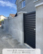 Close-up view of a driveway gate automation motor installed at the base