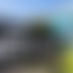 Una fotografía de la oficina corporativa de Abbott. Un cartel negro con el logotipo blanco de Abbott y la dirección está en primer plano. El edificio de la empresa, de color gris y con grandes ventanales, se encuentra en un día soleado.