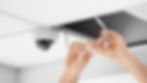 Technician installing CCTV camera on ceiling indoors.jpg