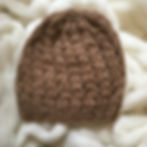 Photo of a dark fawn knitted hat made from alpaca wool.