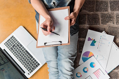 Top view of person analyzing a specific project and preparing reports