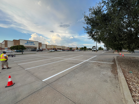 Large parking lot in Ardmore Oklahoma being striped with machine and fresh white lines