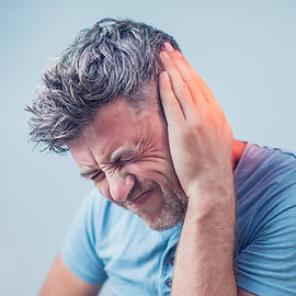 Tinnitus testing and treatment - Man with tinnitus pain