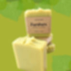 kawakawa soap with green background and kawkawa leaves