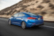 brand new hyundai elantra turbo sport in blue driving on the road