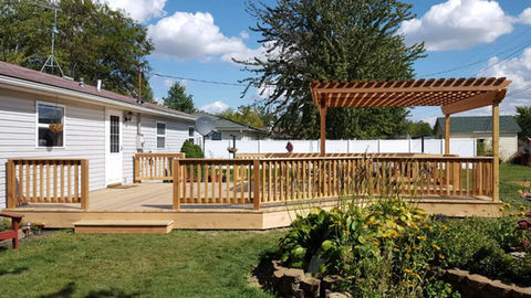 Lattice-style pergola providing shade and style over a spacious deck with outdoor furniture.