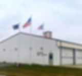 Paulding OH Fire Dept Flagpoles. Three external halyard flagpoles side by side, featuring tapered aluminum design, cleats, and ball toppers