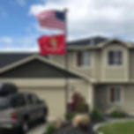 Close-up of Titan telescoping flagpole with 3-inch diameter and 4’x6’ embroidered USA flag & marines flagattached.