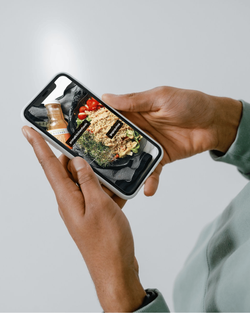 Phone screen showing social media post tagging Primal Kitchen Foods and GoGo Quinoa, highlighting our social media content creation and influencer marketing services.