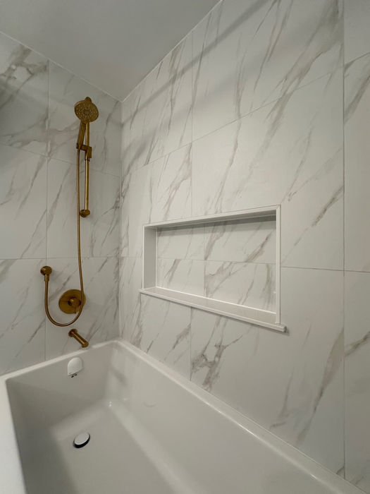 RenoVision Interiors Marble Tile Bathroom