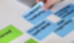 Developing a Theory of Change with writting on blue cards of paper.