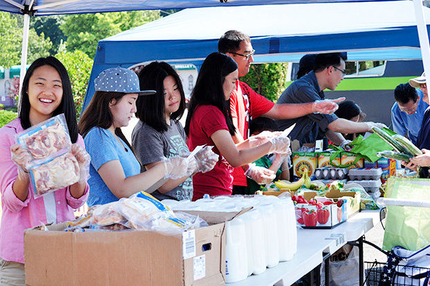 Volunteers help distribute food to families in need