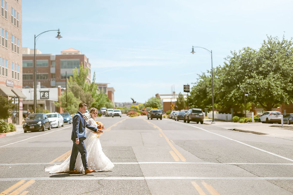 Bride and groom walking in downtown St. George Utah for their wedding photos.