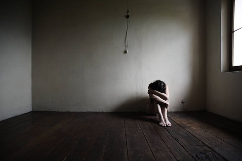 depressed woman sitting by wall head down (1).jpeg