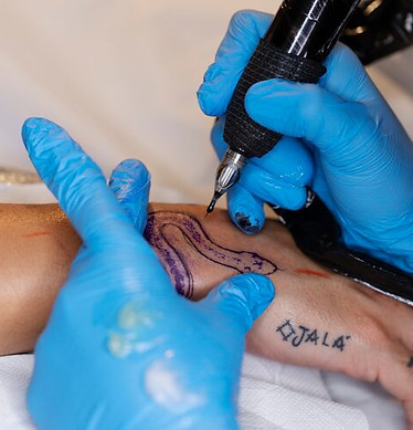 high-angle-tattoo-artist-wearing-gloves_23-2149445967.jpg