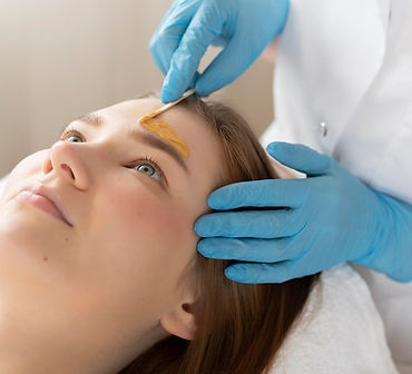 young-woman-getting-eyebrow-treatment-beauty-salon_23-2148879549.jpg