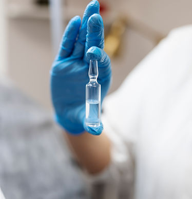 hand-with-glove-holding-vial.jpg