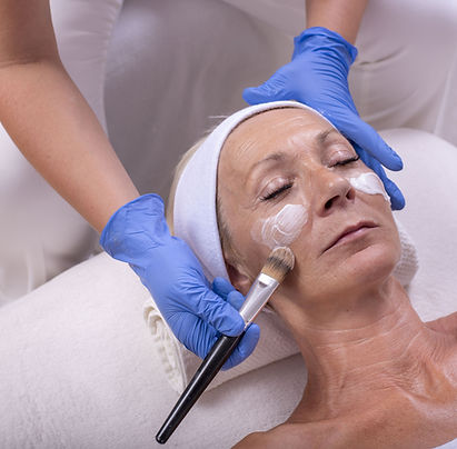 closeup-caucasian-senior-woman-applying-face-cream-beauty-salon.jpg