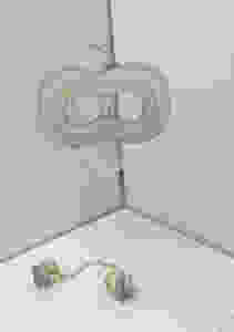 Redesign of a judges gavel with a chain and two weights on either end. Mask hanging above the gavel