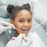 Young girl smiling during a gentle pediatric dental exam