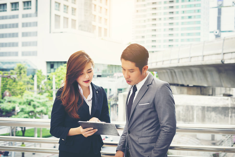 business-man-pointing-document-with-smile-discussing-something-with-her-coworker-while-sta