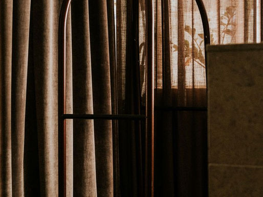 Luxury hotel bellboy trolley in warm evening light, styled interior with linen curtains and brass detailing, hospitality brand experience concept