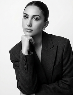 Minimal black and white portrait of Carly, Founder of JUDE Marketing & Creative, styled in a tailored blazer, reflecting a calm and intentional creative leadership approach.