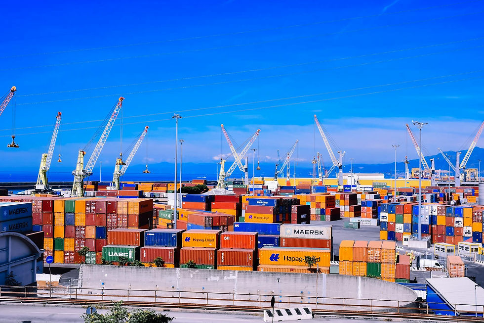 Colorful shipping containers stacked at a busy port under blue sky for global trade logistics