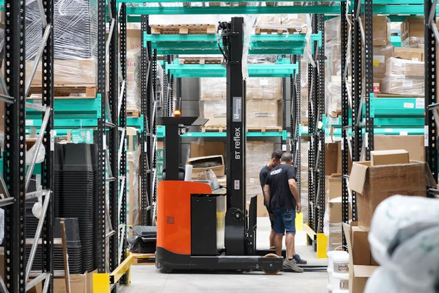 Modern warehouse operations with forklift and workers for Amazon FBA fulfillment logistics