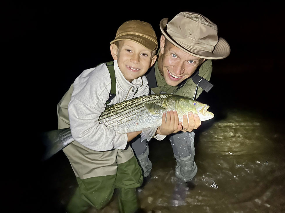 Elliot Bunce cradles his first Martha's Vineyard striped bass.