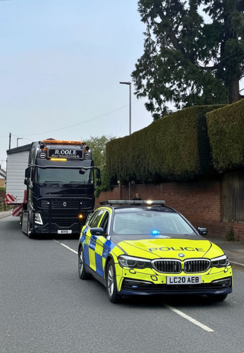 Specialist transport vehicle delivering a large lodge safely across the UK