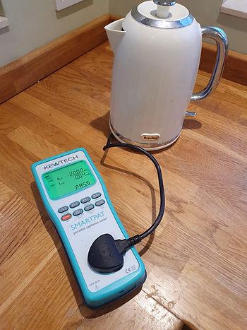 Portable appliance testing equipment checking electrical safety of office devices