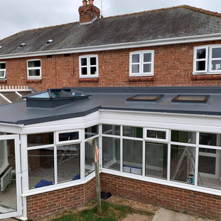 Modern replacement conservatory roof creating a warm and comfortable living space.