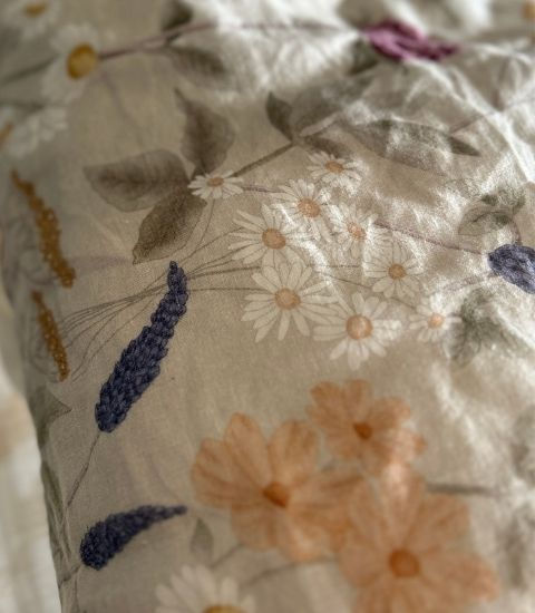 Close-up of soft floral linen pillowcase showing natural texture, breathable weave, and relaxed crumpled finish.