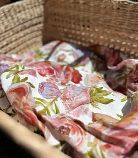 Blossom Blush French flax linen placed in a woven basket