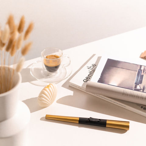 Flint fire lighter in gold colour placed on a countertop. 