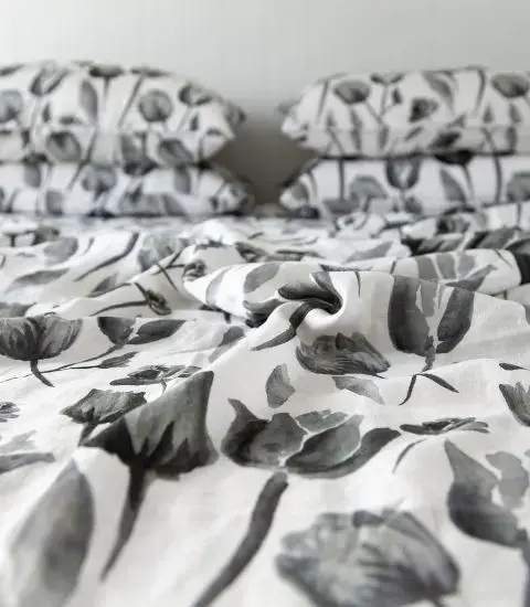 Midnight Garden floral French flax linen flat sheet and pillowcases styled on a bed