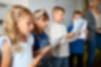 medium-shot-kids-singing-together-sunday-school.jpg