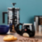 Feline Fine Black Cat Shaped Mug with cat tail handle on a desk