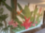 Tropical plant mural with large green leaves and red flowers