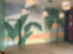 Mural with tropical banana leaf patterns on an interior wall