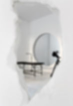 custom designed mirror that looks deconstructed, white broken wall, reflecting modern designed tattoo parlor