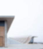 Curved staircase and amphitheater rooftop at Lahofer Winery, wood-clad and concrete building