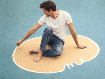 Man sitting inside a drawn outline on the ground — symbolic image for social boundaries, self-protection, and personal integrity.