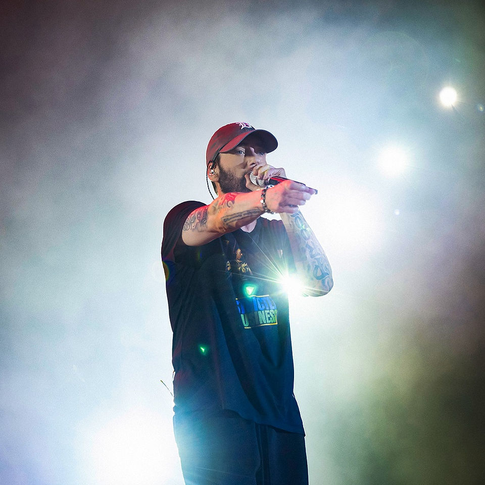 Man with microphone points out towards camera