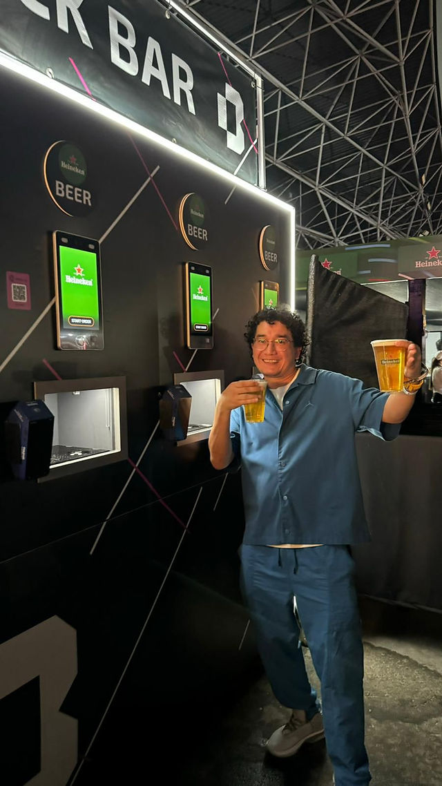 Man with two beers smiling