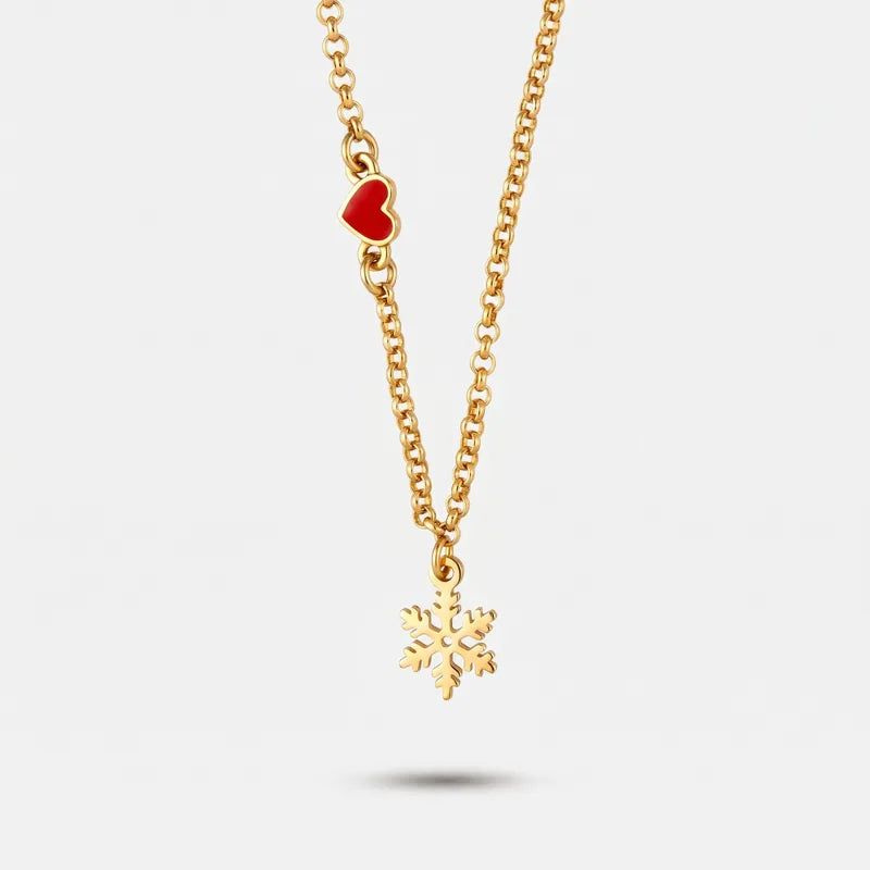 Collana BySimon con fiocco di neve dorato centrale e cuore rosso laterale.