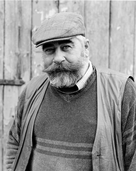 Older man with mustache, beard, flat cap, hand printed analogue portrait.