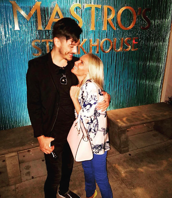 Joseph Stanek shares a warm moment with Kristin Chenoweth outside Mastro’s Steakhouse, smiling and embracing after a night of music and friendship.