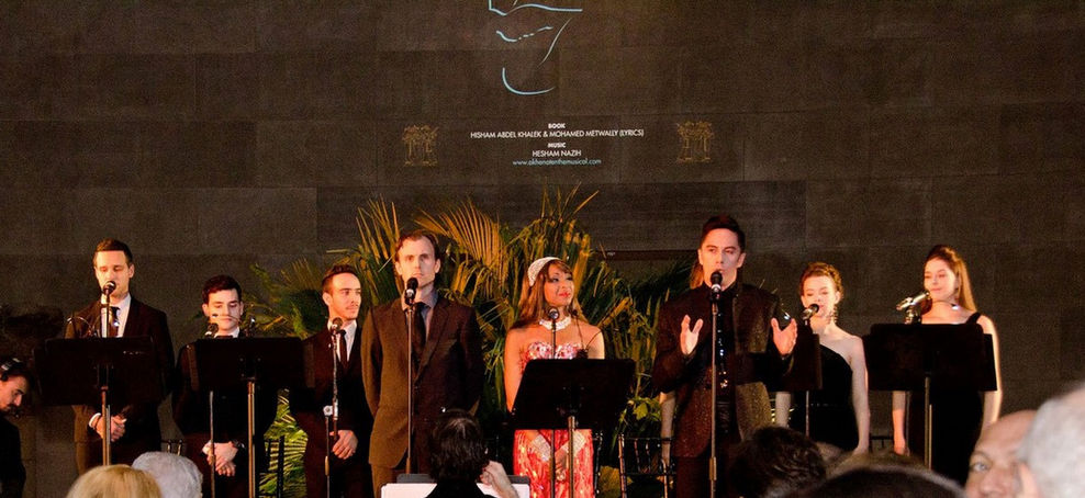 Joseph Stanek performs with the cast of Akhenaten the Musical at the United Nations annual gala, set against the stunning backdrop of the Temple of Dendur.